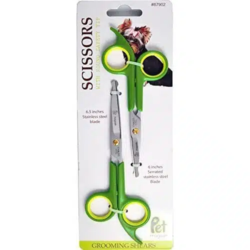 Green grooming scissors over white background